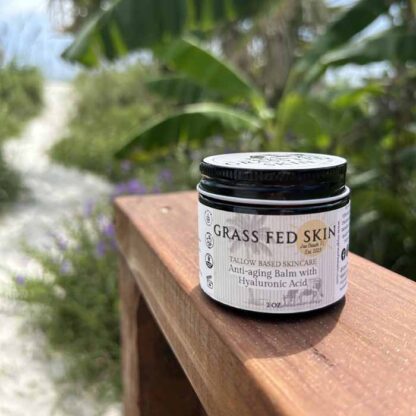 Hyaluronic Acid Anti-Aging Tallow Cream shown with a beach scene background.