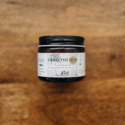 Grass Fed Skin Hyaluronic Acid Anti-Aging Tallow Cream on wood table.